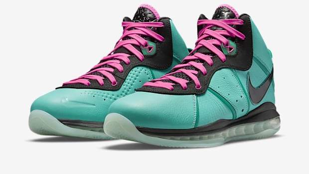 Side view of LeBron James' teal and black Nike sneakers.